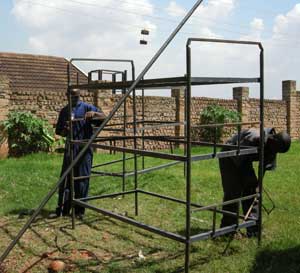 Men making triple bunk beds